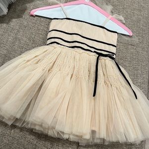Ivory crinoline dress with black bow trim